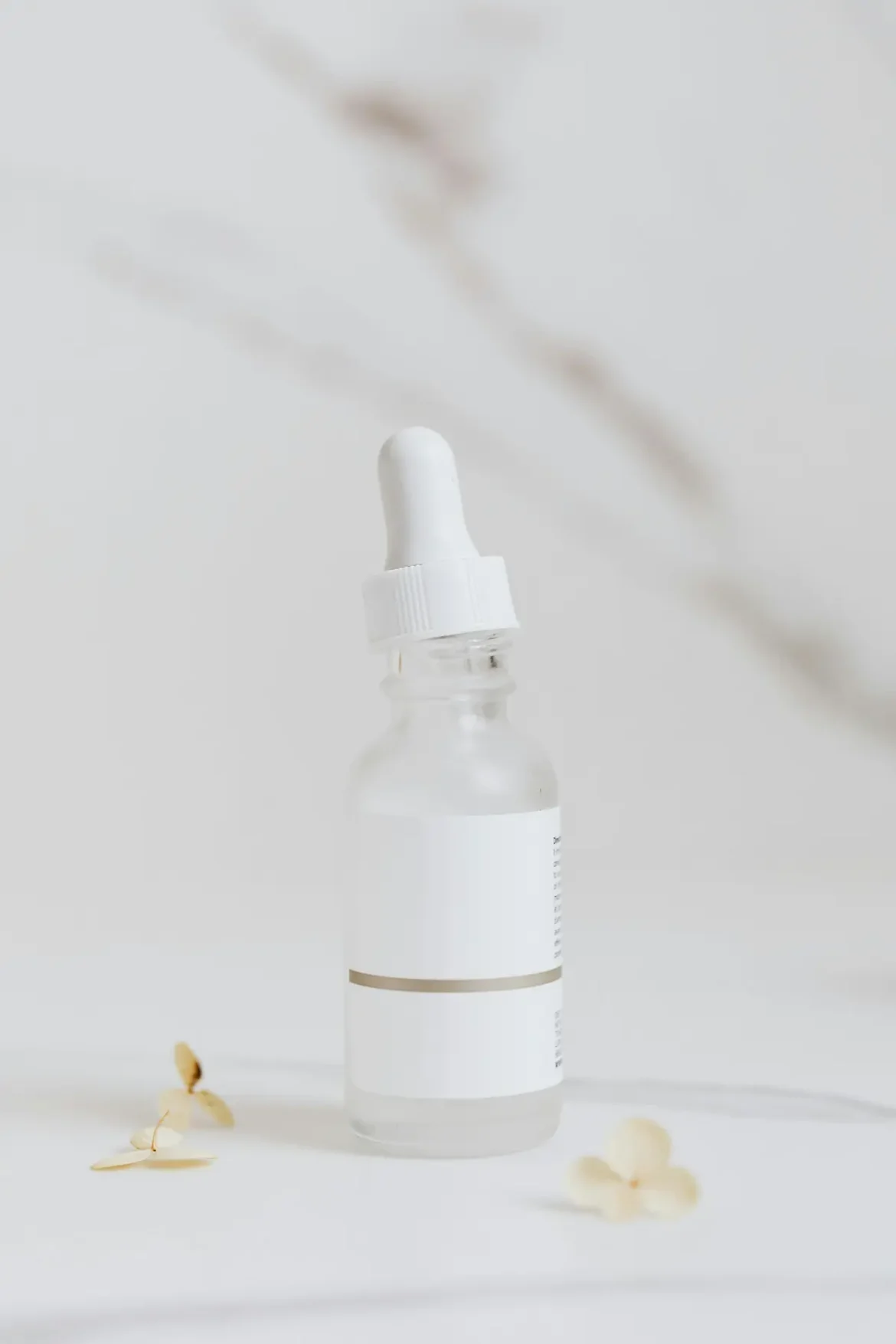 Minimalist Korean serum bottle on white background for glowing skin.