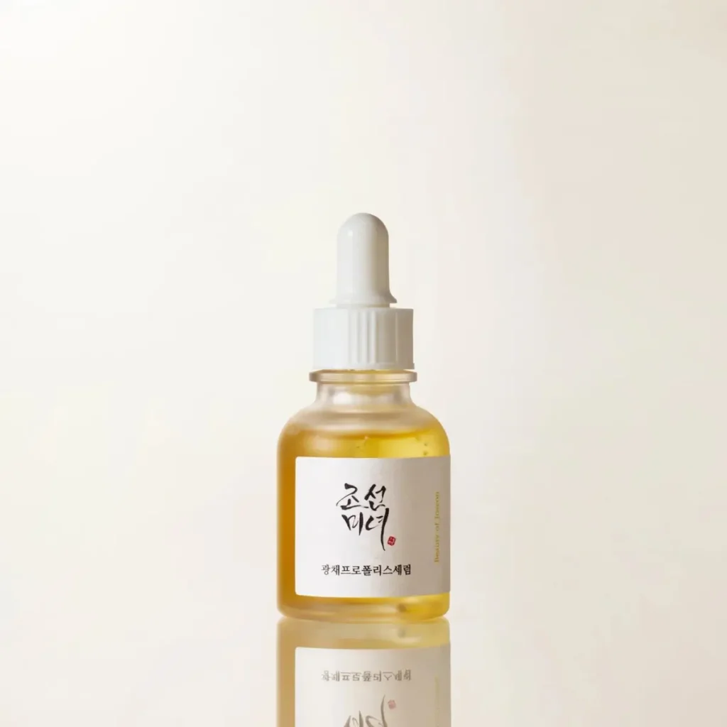 Propolis serum bottle with dropper on a neutral backdrop
